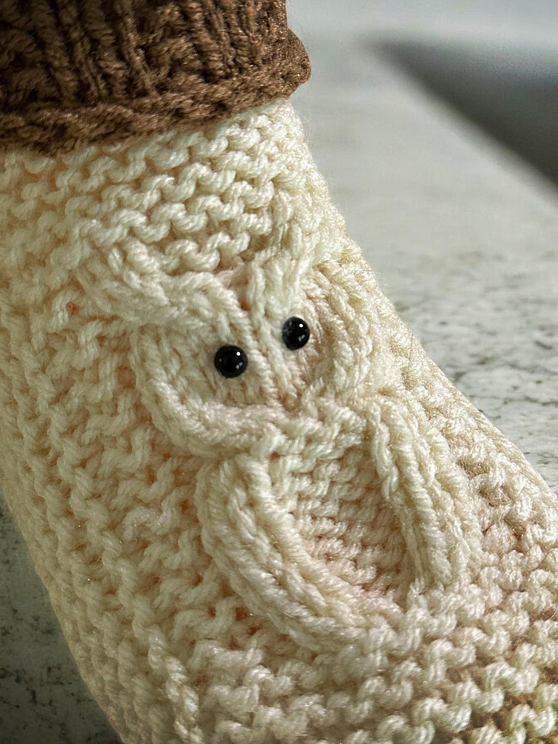 close up of cable owl design on knitted slippers straight needle knitting pattern