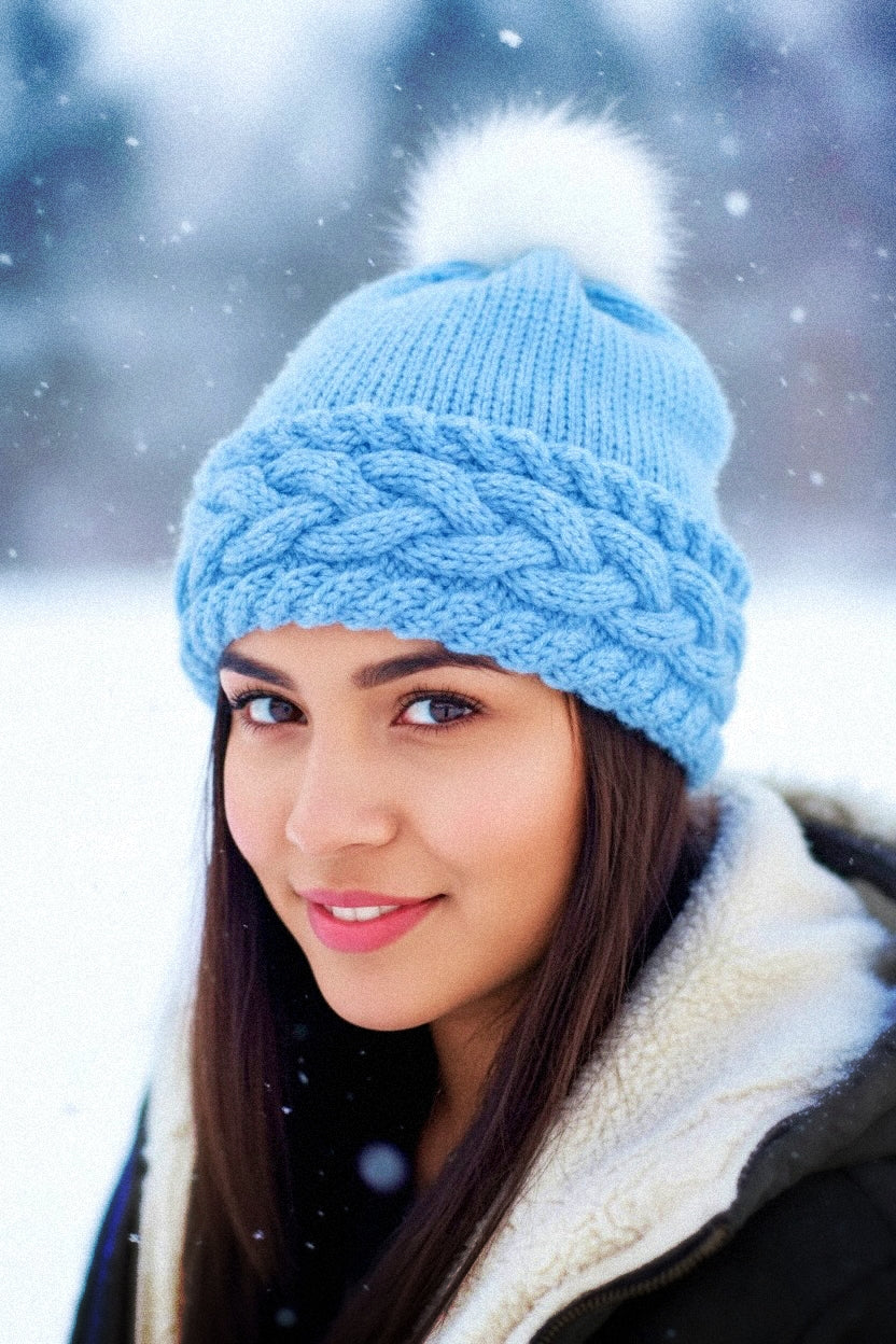 Person wearing warm cable knit beanie with folded brim from knitting pattern