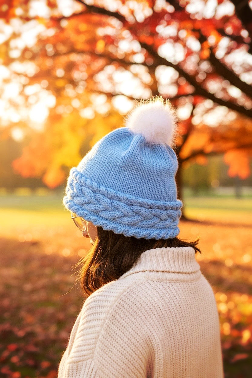 Person wearing cozy cable bobble beanie from knitting pattern with double brim