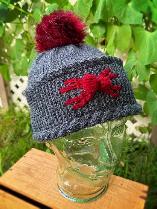 Handmade knitted winter beanie featuring a spooky spider design