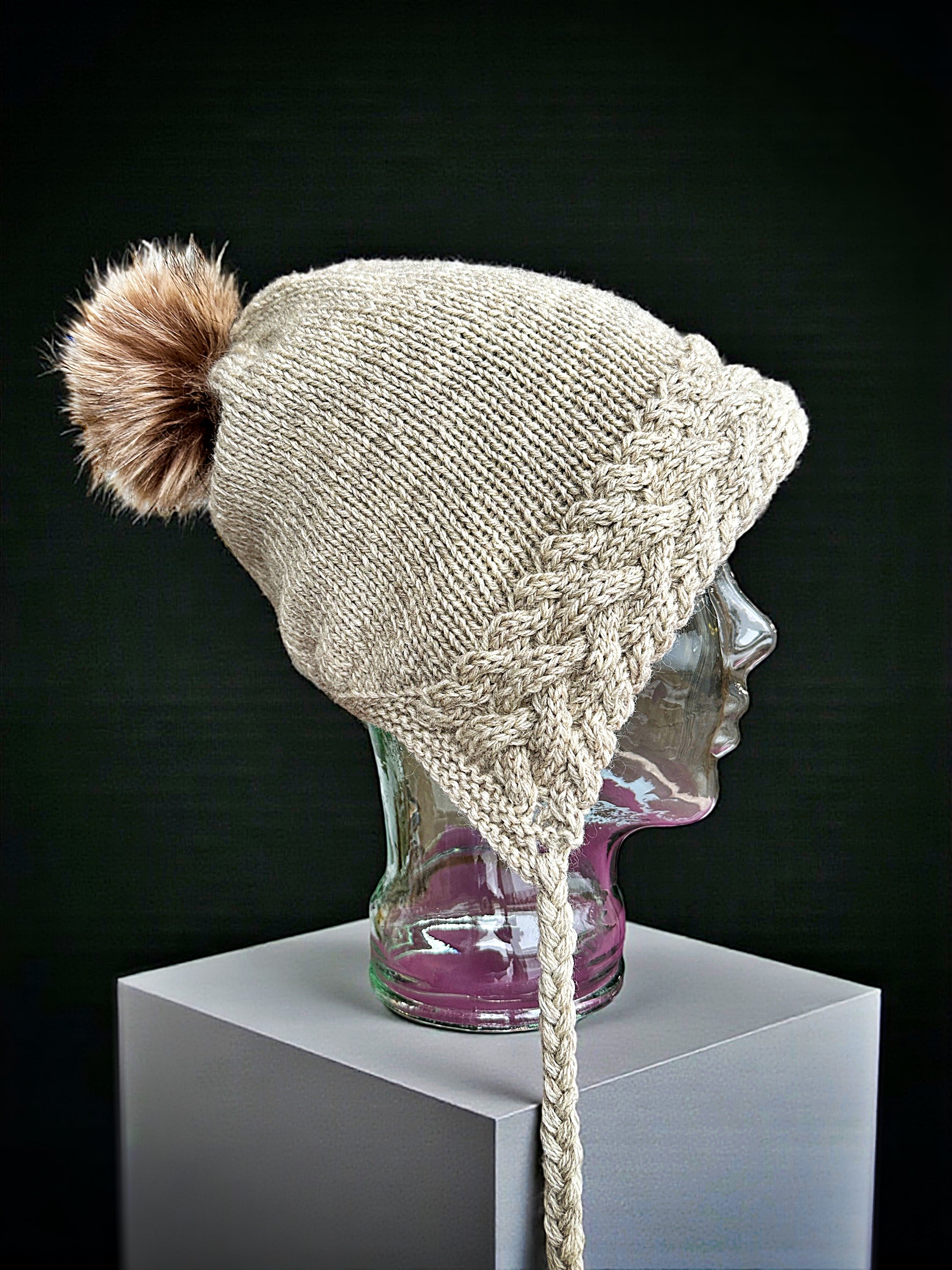 Adult winter hat with bobble and classic cable design, knit flat
